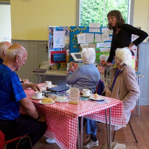 A group of people seated at a table, taking part in a community engagement workshop